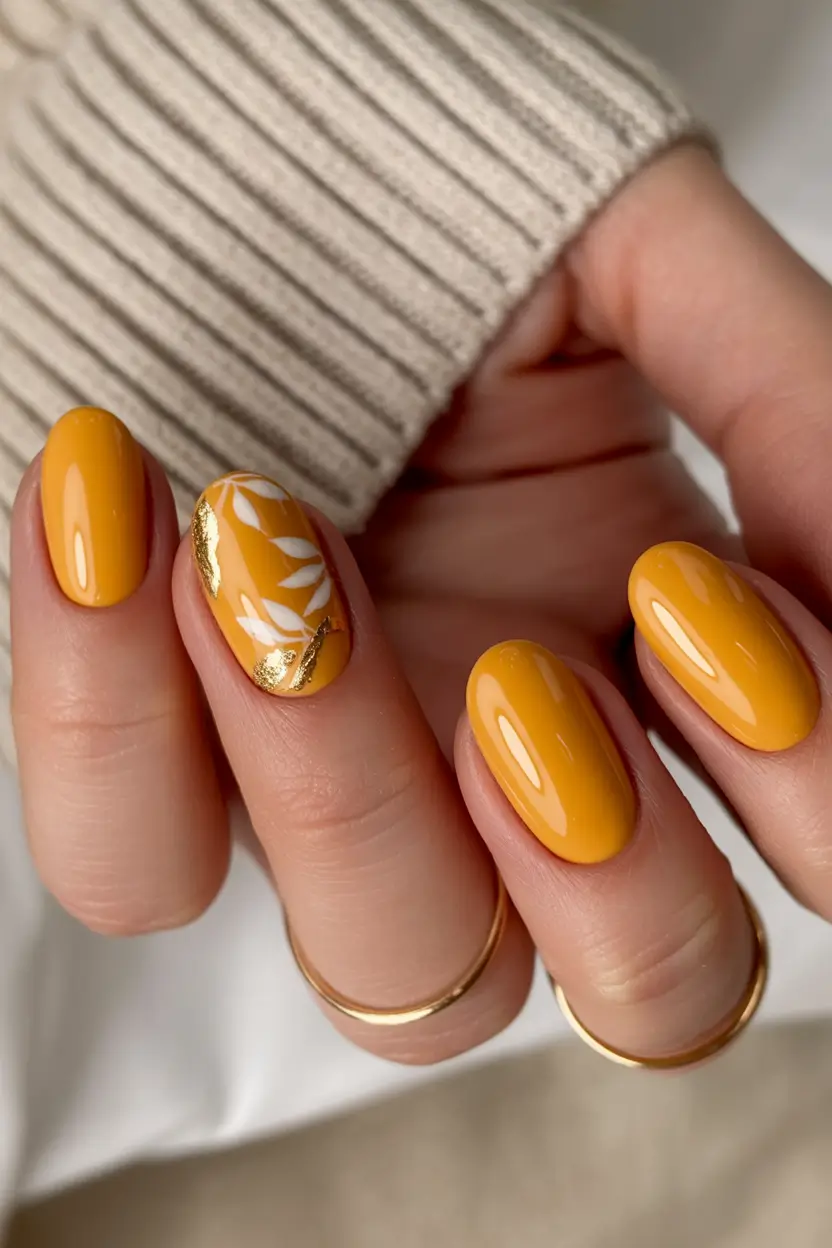 Stylish Fall Oval Shape Nail Designs 2025 Golden Mustard with Leaf Art