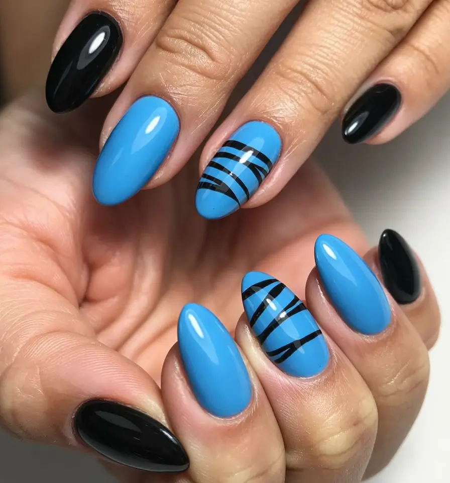 Almond nail art ideas 2026 Blue Almond Nails With Minimal Black Line Accents