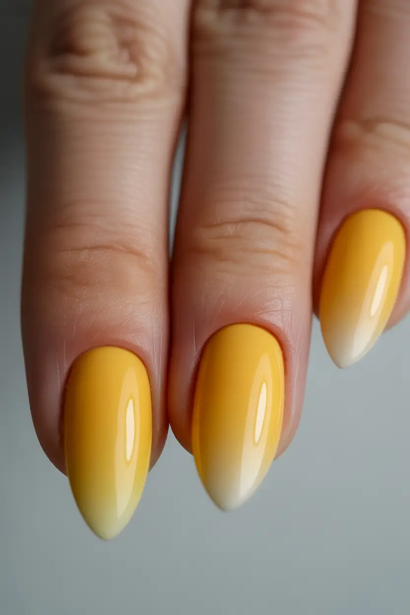 simple short almond nails 2026 Soft Yellow Ombré Almonds With a Sunlit Finish