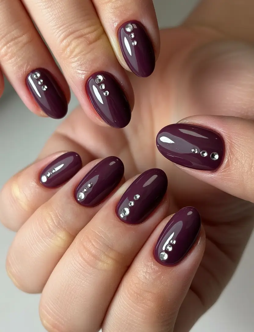 simple short almond nails 2026 Deep Plum Almond Nails With Minimal Crystal Details